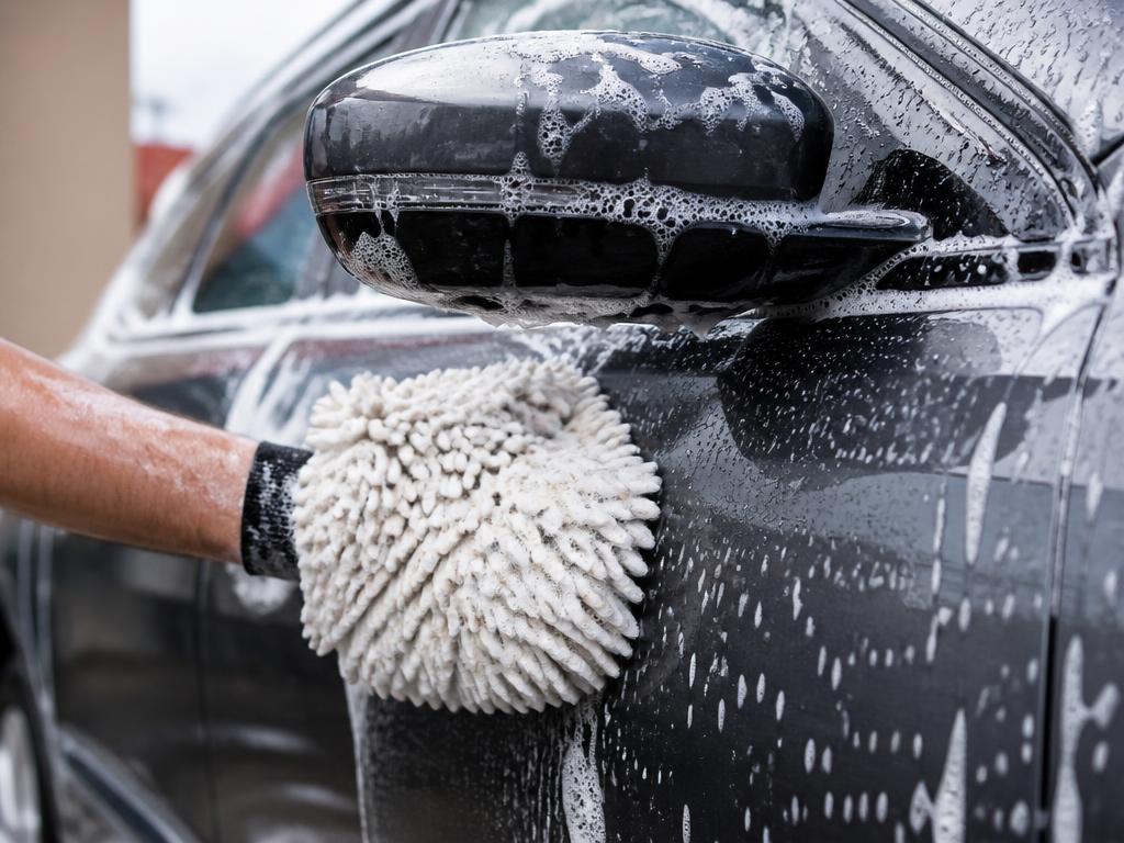 Car covered in soap suds during a hand wash